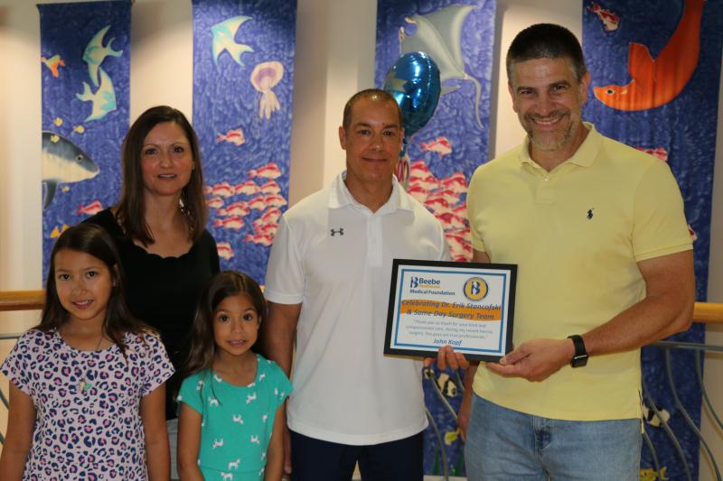 Linda and John Kopf, with their daughters, Kaitlyn and Sarah, celebrate John’s excellent care provided by Dr. Erik Stancofski, right, and Beebe’s Same-Day Surgery Team. SUBMITTED PHOTO